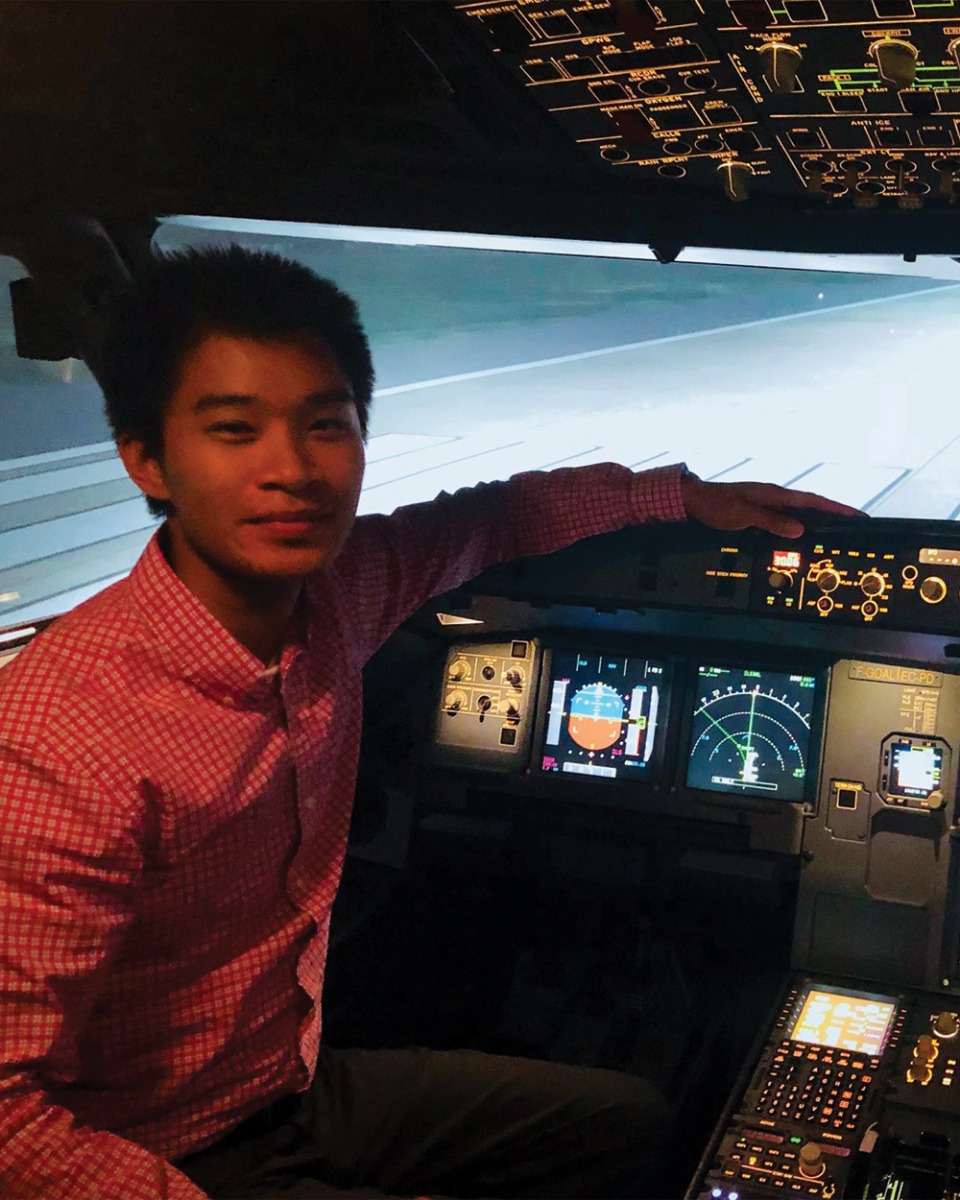 Alan Nguyen in cockpit of plane simulator