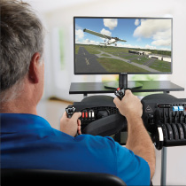 person using flight simulator equipment at desktop computer