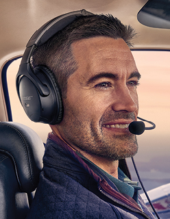 male pilot flying plane wearing Bose headset